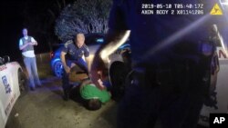 This image from video from Louisiana state trooper Lt. John Clary's body-worn camera shows trooper Kory York standing over Ronald Greene on his stomach on May 10, 2019, outside of Monroe, La. (Louisiana State Police via AP)