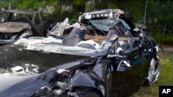 FILE - In this photo provided by the National Transportation Safety Board via the Florida Highway Patrol, a Tesla Model S that was being driven by Joshua Brown, who was killed when the Tesla sedan crashed while in self-driving mode on May 7, 2016. The NTSB released the results of its investigation Monday.