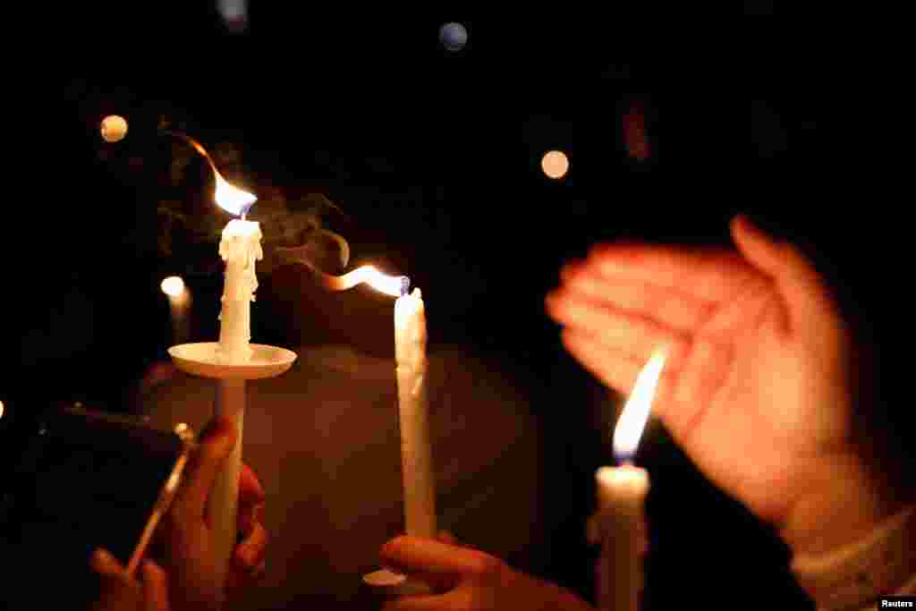 People attend a candlelight vigil for victims of yesterday's shooting at nearby Marjory Stoneman Douglas High School, in Parkland, Florida, U.S. Feb. 15, 2018. 