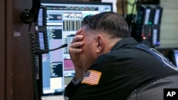 Trader Jonathan Mueller works in his booth on the floor of the New York Stock Exchange, Oct. 26, 2018. 