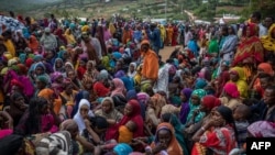 Ethiopian refugee women wait to receive non-food items distributed by the Kenyan Red Cross at the newly built Somare refugee camp in Moyale, Kenya's border town with Ethiopia, on March 19, 2018.