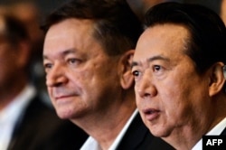 FILE - Interpol Vice President Alexander Prokopchuk, left, and Meng Hongwei, then-president of Interpol, are seen at the opening of the Interpol World Congress, in Singapore, July 4, 2017.