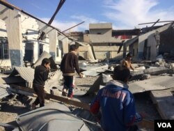 Children play in what was once their schoolhouse, and later occupied by IS militants before it was bombed in an airstrike on Jan. 19, 2017 in Mosul Iraq. (H.Murdock/VOA)