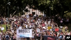 People gather at Hyde Park during the Women's March rally protesting the start of Donald Trump's presidency, in Sydney, Australia, Jan. 21, 2017.