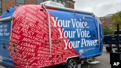 FILE - A 5.8-meter Airstream Caravel on loan to the League of Women Voters of Ohio visits the main campus of the Ohio State University in Columbus, Ohio, Sept. 26, 2024, as the group works to register and engage student voters. 
