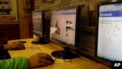 FILE - An Indian man surfs a Facebook page at an Internet cafe in New Delhi, India, Tuesday, Feb. 9, 2016.