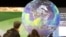 FILE - People watch the Earth globe at the COP21, the United Nations conference on climate change in Le Bourget, Dec. 10, 2015. 