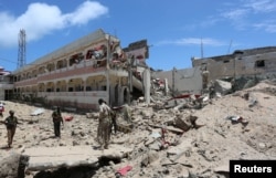 FILE - Security forces stand at the SYL hotel that was partly destroyed following a car bomb claimed by al Shabaab Islamist militants outside the president's palace in the Somali capital of Mogadishu, Aug. 30, 2016.
