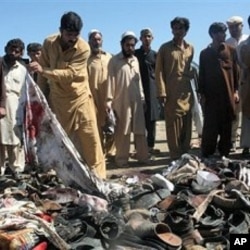 Pakistani villagers search for the belongings of their family members after a blast in Matani near Peshawar, Pakistan, March 9, 2011