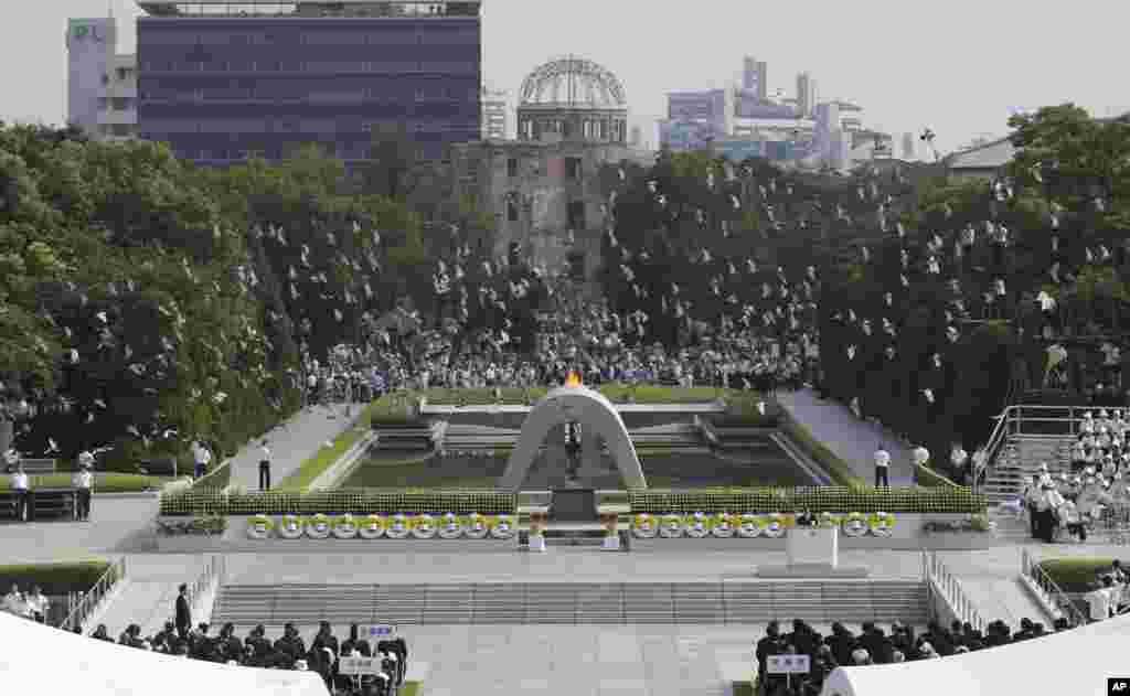 Doves fly over the cenotaph dedicated to the victims of the atomic bombing at the Hiroshima Peace Memorial Park during the ceremony to mark the 68th anniversary of the bombing, August 6, 2013.