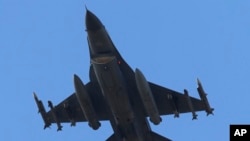 FILE - A missile-loaded Turkish Air Force jet after taking off from Incirlik Air Base, in Adana, southern Turkey, July 29, 2015. 
