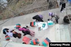 A group of women painting the memory boxes in Kabul, Afghanistan. (Photo: Afghanistan Human Rights and Democracy Organization)