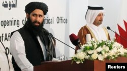 Muhammad Naeem (L), a spokesman for the Office of the Taliban of Afghanistan, speaks during the opening of the Taliban Afghanistan Political Office in Doha, June 18, 2013. 