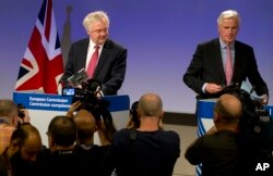 FILE - EU Chief Brexit Negotiator Michel Barnier, right, and British Secretary of State for Exiting the EU David Davis arrive for a media conference at EU headquarters in Brussels, June 19, 2017.
