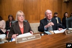 Sen. Patty Murray, D-Wash., and Sen. Lamar Alexander, R-Tenn., meet before the start of a hearing on Capitol Hill in Washington, Oct. 18, 2017.