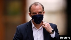 FILE - Britain's Foreign Affairs Secretary Dominic Raab walks outside Downing Street in London, Britain, Feb. 3, 2021. 
