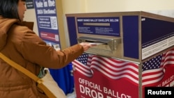 A voter casts their ballot during early voting, a day ahead of the Super Tuesday primary election, at the San Francisco City Hall voting center in San Francisco, California, March 4, 2024.