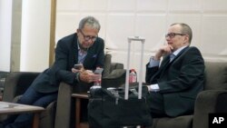 FILE - Picture released by Islamic Republic News Agency, IRNA, shows Tero Tapio Varjoranta, Deputy Director General and Head of the Department of Safeguards of the International Atomic Energy Agency, IAEA (R), next to an unidentified colleague upon their arrival at the Imam Khomeini airport just outside Tehran, Iran, April 15, 2015. 