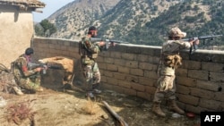 FILE - Afghan security forces take part in an ongoing operation against Islamic State militants in the Achin district of Nangarhar province, Nov. 25, 2019.