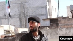 Eyad Aljarod stands on a rooftop after covering an anti-government demonstration in Saraqib, Syria, Dec. 29, 2012. (Courtesy photo)