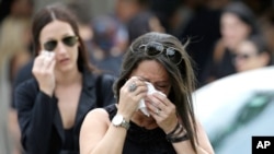Mourners cry as they leave the funeral service for Anthony Luis Laureano Disla, one of the victims of the Pulse nightclub mass shooting, in Orlando, Florida, June 17, 2016.