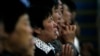 FILE - A woman prays with other villagers during a mass in the morning at the Liuhe Catholic Church in Liuhe village on the outskirts of Qingxu county, northern China's Shanxi province, Sept. 11, 2011.