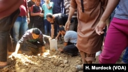 Family and friends bury the body of a 51-year-old man killed at a rally this week in Gaza on May 16, 2018. 