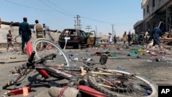 A damaged bicycle is seen at the site of a suicide attack in Kabul, Afghanistan, July 25, 2019. Afghan police say a suicide bomber blew himself up Thursday in front of a bus carrying Ministry of Mines employees.