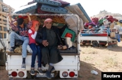 FILE - Syrian refugees prepare to return to Syria from the Lebanese border town of Arsal, Lebanon, June 28, 2018.