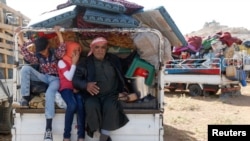 FILE - Syrian refugees prepare to return to Syria from the Lebanese border town of Arsal, Lebanon, June 28, 2018. 