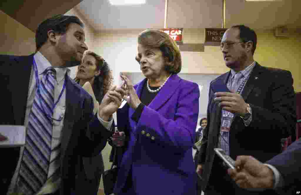 Senate Intelligence Committee Chair Sen. Dianne Feinstein, D-Calif. is pursued by reporters as she arrives to release a report on the CIA's harsh interrogation techniques at secret overseas facilities, on Capitol Hill in Washington, Dec. 9, 2014.