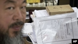 Artist Ai Weiwei with notice from city's Chaoyang District police that restrictions would expire Friday, Beijing, June 21, 2012.