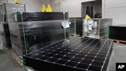 FILE - SunPower solar panels are stacked in Positive Energy Solar's warehouse in Albuquerque, New Mexico, March 9, 2016. The United States spent over $11 billion on issues related to climate change in 2014, according to U.S. goverment data.
