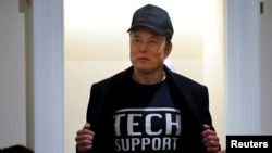 Elon Musk shows off his t-shirt reading "Tech Support" while speaking at the first cabinet meeting hosted by U.S. President Donald Trump, at the White House in Washington, Feb. 26, 2025. 