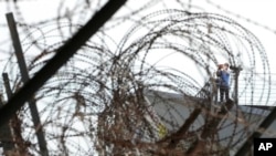 A visitor takes photos toward the North's side at the Imjingak Pavilion in Paju, near the border with North Korea, South Korea, Sept. 24, 2021.