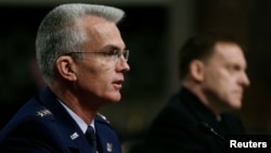 U.S. Navy Vice Admiral Michael Rogers (R) and U.S. Air Force General Paul Selva attend the Senate Armed Services Committee confirmation hearing on Capitol Hill in Washington, March 11, 2014.
