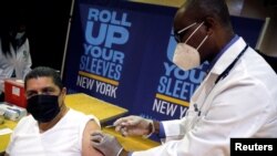 FILE - The Pfizer vaccine is given amid the coronavirus disease (COVID-19) pandemic, in the Harlem section of Manhattan in New York City, New York, April 23, 2021. 
