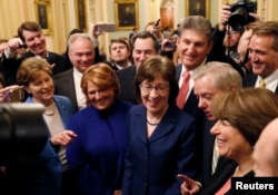 U.S. Senators' Susan Collins (R-ME) addresses reporters with fellow Senators' Jeanne Shaheen (D-NH), Tim Kaine (D-VA), Heidi Heitkamp (D-ND), Joe Manchin (D-WV), Lindsey Graham (R-SC), Amy Klobuchar (D-MN) and Jeff Flake (R-AZ).