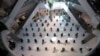 People practice social distancing as they sit on chairs spread apart in a waiting area for take-away food orders at a shopping mall in hopes of preventing the spread of the coronavirus in Bangkok, Thailand, March 24, 2020.