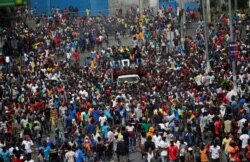 Demonstrators march during a protest to demand the resignation of Haitian president Jovenel Moise, in the streets of Port-au-Prince, Haiti, Oct. 11, 2019.