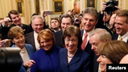 U.S. Senators' Susan Collins (R-ME) addresses reporters with fellow Senators' Jeanne Shaheen (D-NH), Tim Kaine (D-VA), Heidi Heitkamp (D-ND), Joe Manchin (D-WV), Lindsey Graham (R-SC), Amy Klobuchar (D-MN) and Jeff Flake (R-AZ) after lawmakers struck...