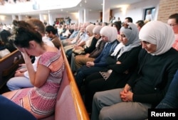 People from different faiths pray during an interfaith vigil for the victims of the Tennessee shooting, at Olivet Baptist church in Chattanooga, Tennessee, July 17, 2015.