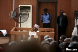 FILE - Nigeria's Senate President Bukola Saraki looks from the dock at the Code of Conduct Tribunal at Darki Biu, Jabi Abuja, Nigeria, Sept. 22, 2015.
