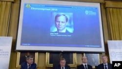 The Nobel prize committee announces Jean Tirole, scientific director at the Institut d'Économie Industrielle, Toulouse School of Economics, in France, photograph on screen, as the winner of the 2014 Sveriges Riksbank Prize in Economic Sciences in Memory 