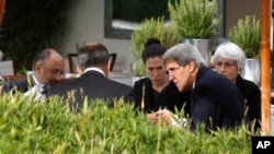 FILE - U.S. Secretary of State John Kerry, second right, and Russian Foreign Minister Sergei Lavrov, back to camera, talk, with their senior aides at a hotel in Geneva, Switzerland, Sept. 14, 2013. For their meetings this weekend on Syria, they will be joined by officials from the Middle East.