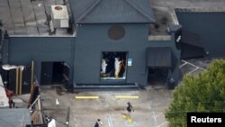 Federal Bureau of Investigation (FBI) officials collect evidence from the Pulse gay night club, the site of a mass shooting days earlier, in Orlando, Florida, June 15, 2016.