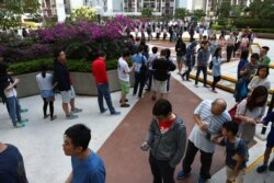 Voters queue to vote at a polling station during district council local elections on Hong Kong Island, China November 24, 2019. REUTERS/Athit Perawongmetha