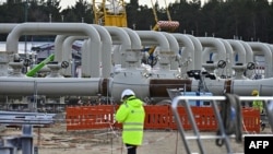 FILE - Men work at the construction site of the Nord Stream 2 gas pipeline in Lubmin, northeastern Germany, March 26, 2019.