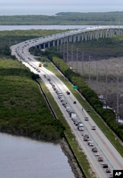 Motorists head north on US 1, Sept. 6, 2017, in Key Largo, Fla., in anticipation of Hurricane Irma. Keys officials announced a mandatory evacuation Wednesday for visitors, with residents being told to leave the next day.