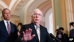Senate Minority Leader Mitch McConnell, R-Ky., joined at left by Minority Whip John Thune, R-S.D., talks with reporters at the Capitol in Washington, June 22, 2021.